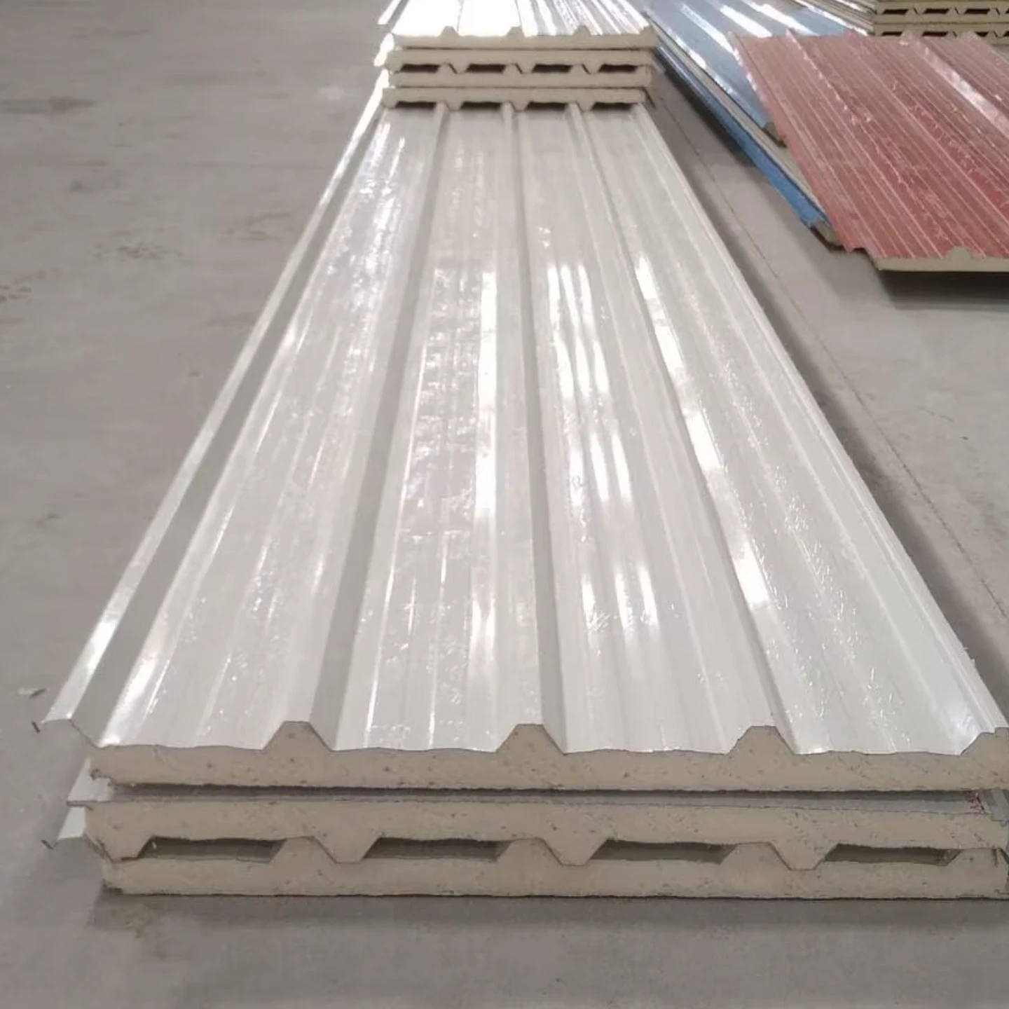 Insulated PUF sandwich roof panel showing foam core between metal skins